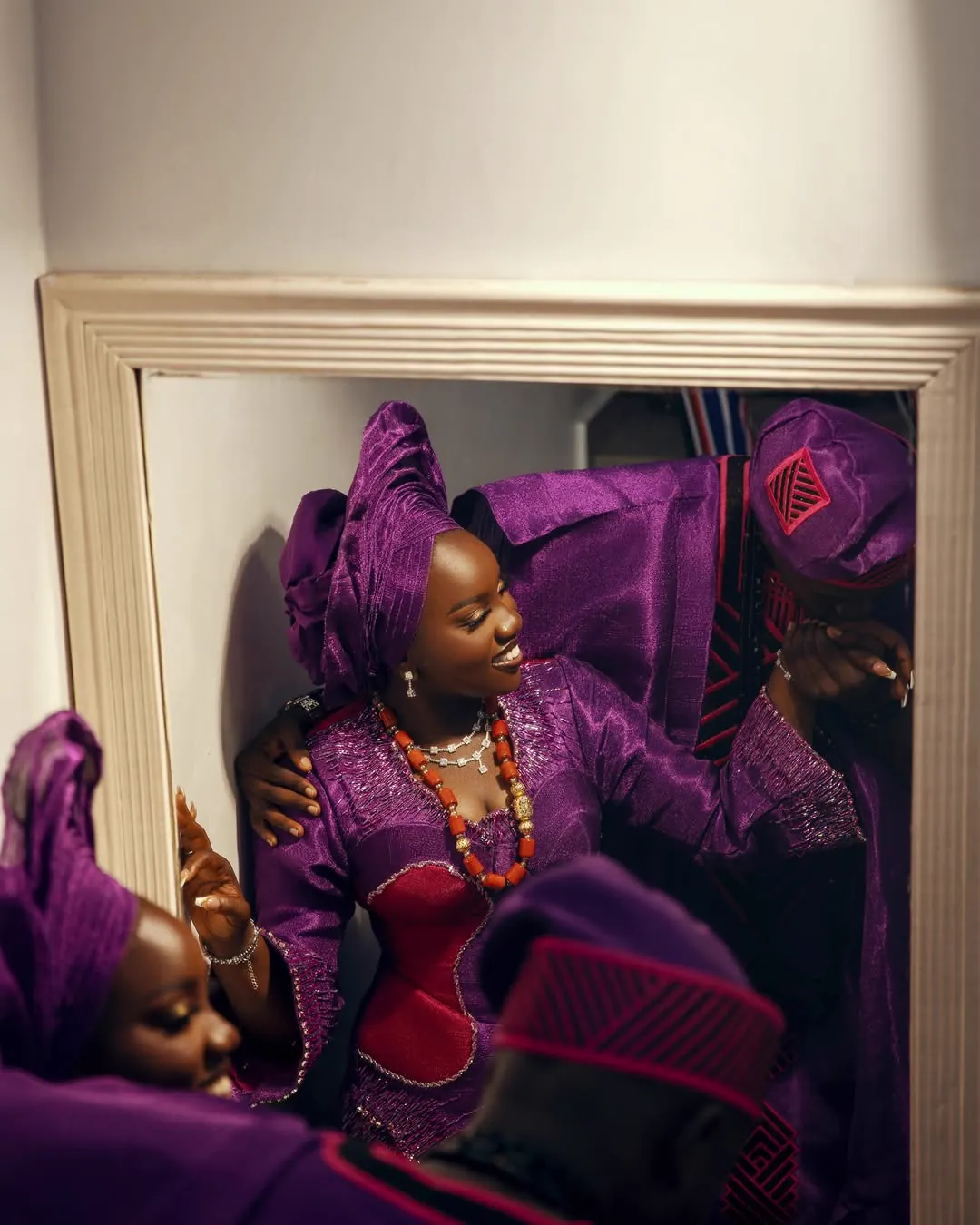 Coordinated Aso Ebi ensemble in purple and gold, tailored by Jiofit in Lagos
