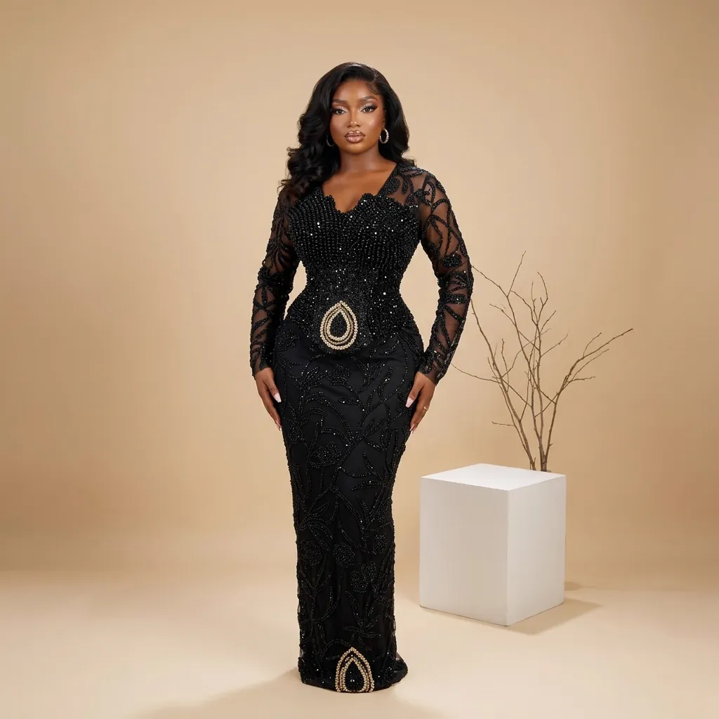 Jiofit Aso Ebi gown in black beaded lace, with sheer long sleeves and a fitted mermaid skirt
