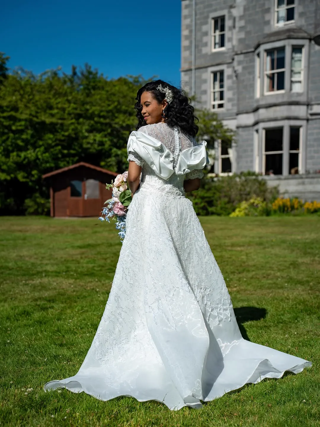 Jiofit bride in lace and satin, photographed on the manor lawn